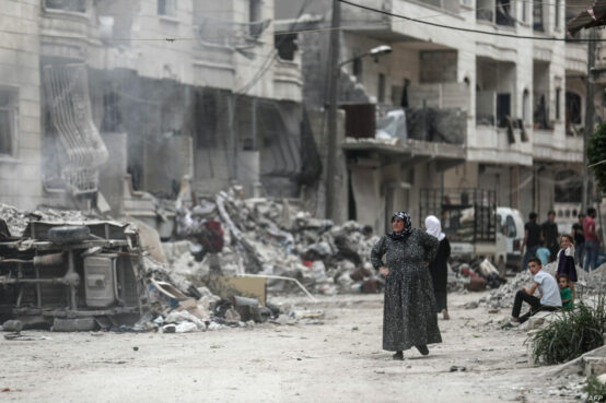 أمرآة سورية تقف على ركام مدينتها